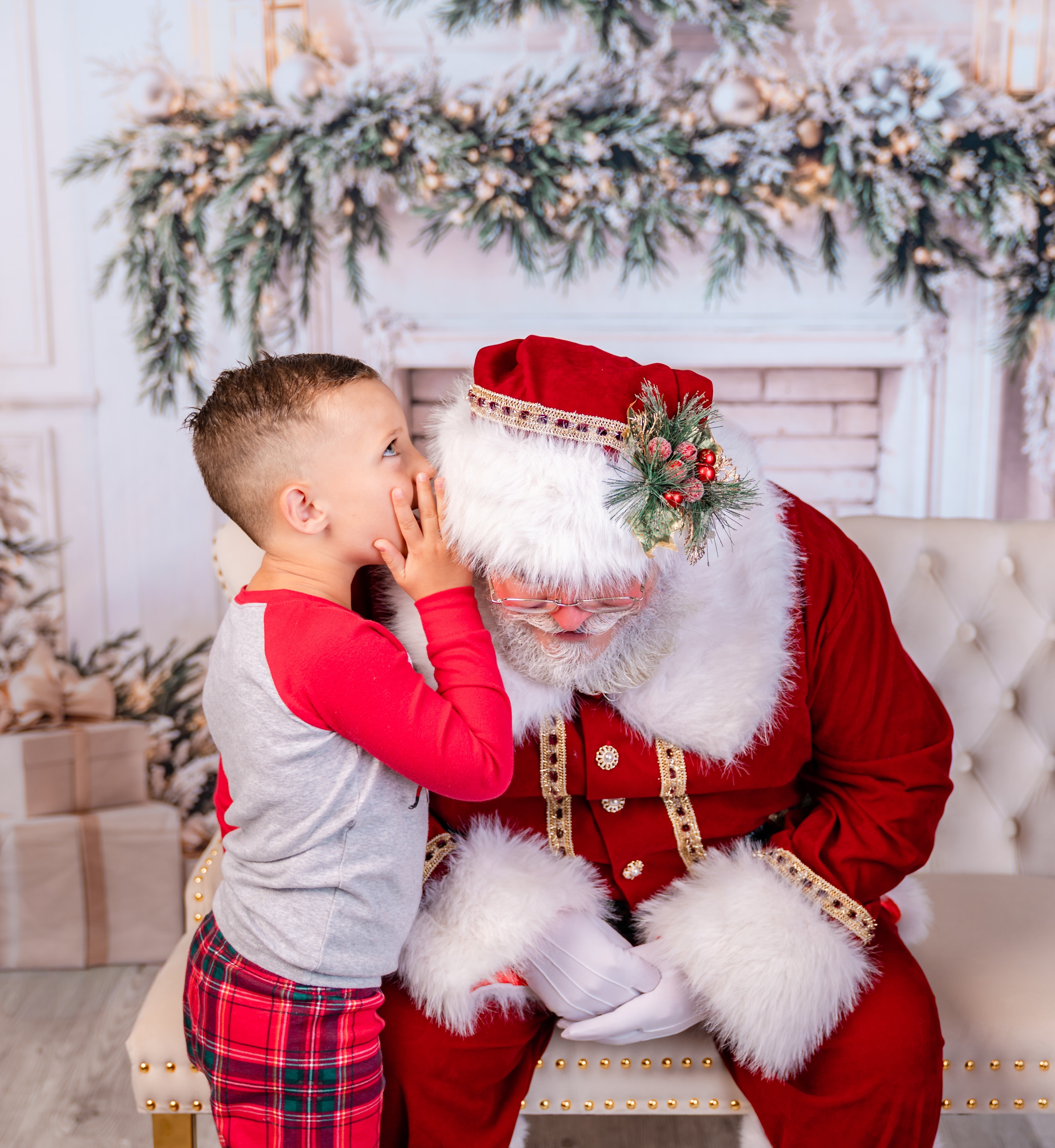 Child whispering a wish to Santa