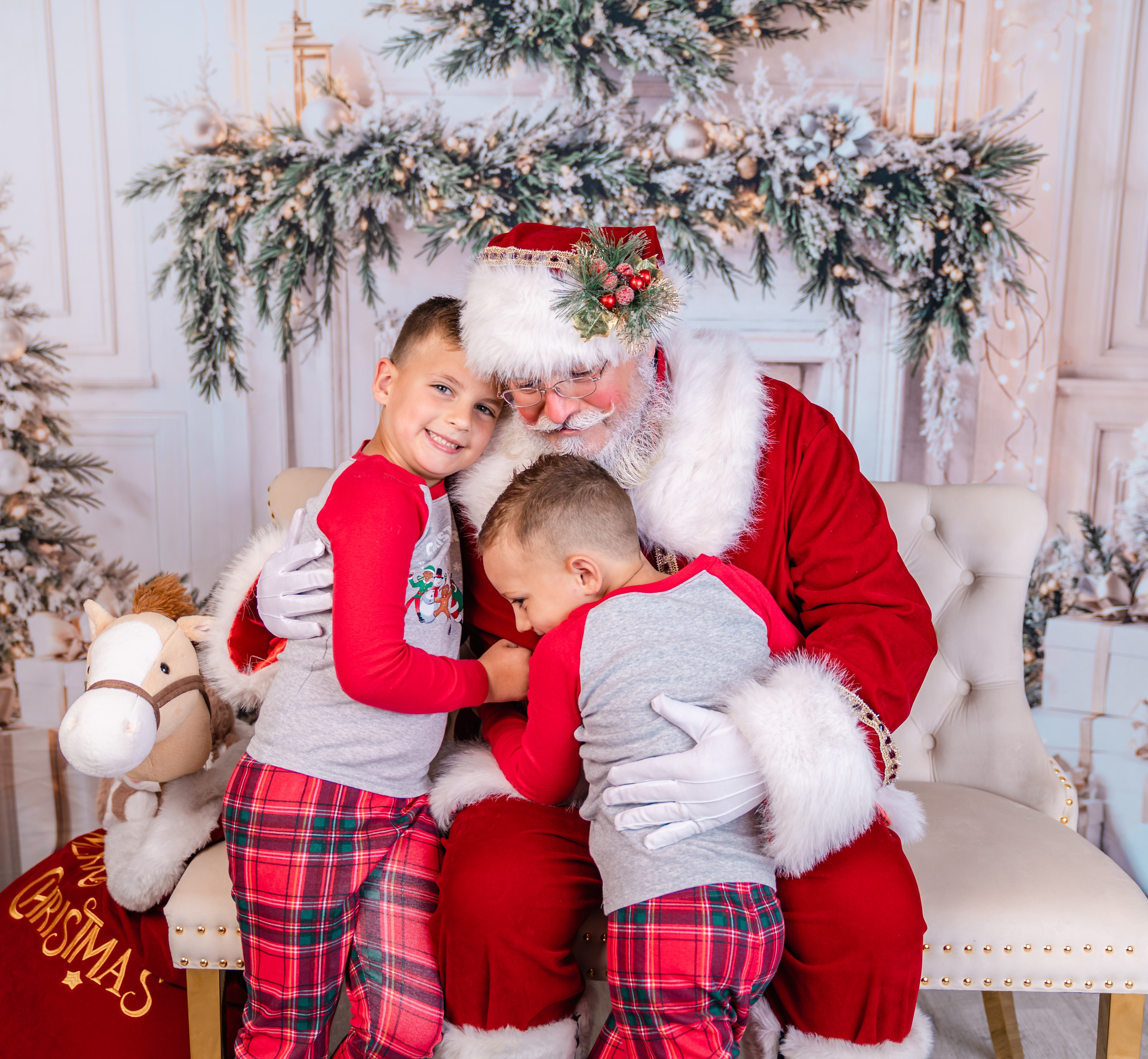 Santa hugging two boys