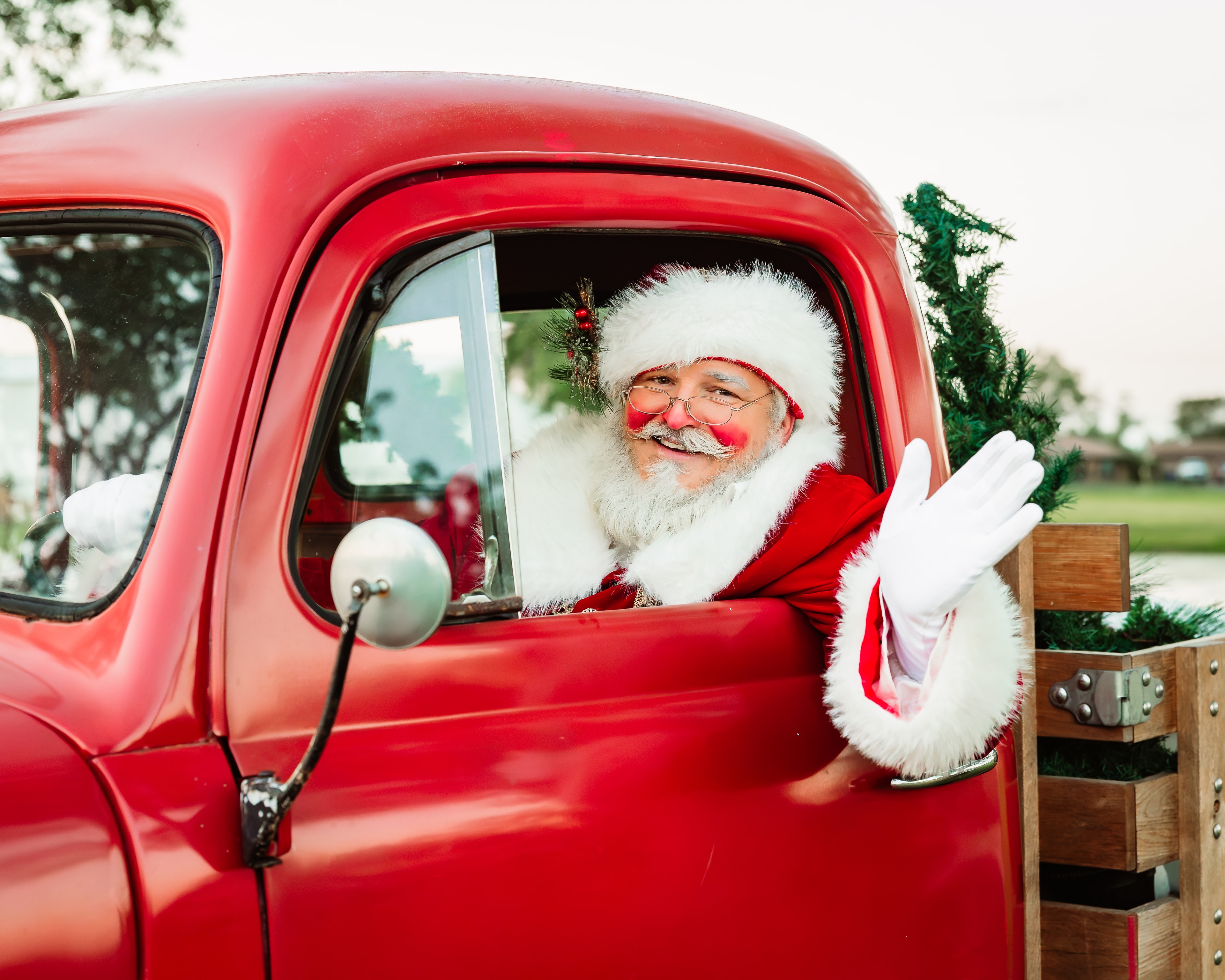 Santa in a red vintage truck